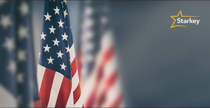 Image of an American flag in foreground and faded American flags in the background